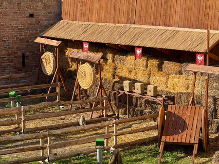 Medieval archery range beside fortress wall. Recreation, historical heritage and outdoor sporting tradition.の写真素材