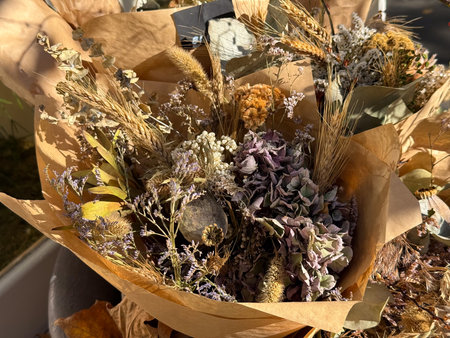Rustic dried bouquet with grains and wildflowers. Natural composition, autumn mood and earthy handmade elegance.の写真素材
