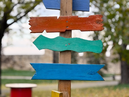 Colorful wooden arrows on post. Creativity, freedom, and joyful navigation conceptの写真素材