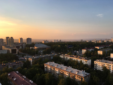 Wide view of Ufa with residential buildings, circus and a ferris wheel in the distance. Modernization, harmony, and rhythm of urban life.の写真素材