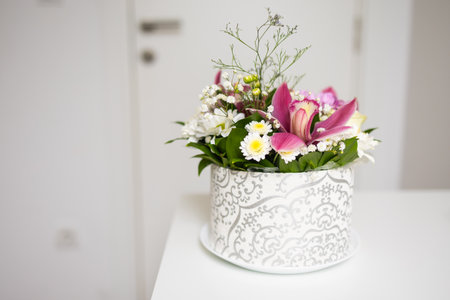Bouquet of pink and white flowers in decorative box. Copy space. Celebration, tenderness, and natural beauty of floral composition.の写真素材