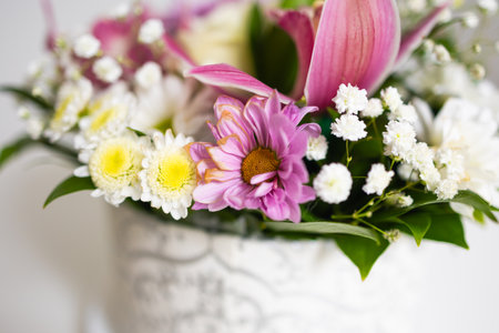 Soft floral arrangement with pink, white, and yellow flowers. Celebration, peace, and freshness of everyday beauty.の写真素材