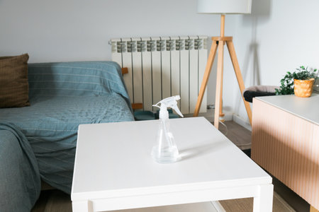 Spray bottle on white table. Cleanliness, freshness, and quiet comfort of modern household simplicity.の写真素材