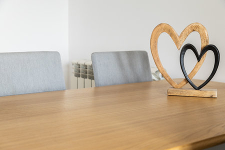 Wooden and metal hearts on table. Emotional closeness, affection, and timeless beauty of shared connection. Copy spaceの写真素材