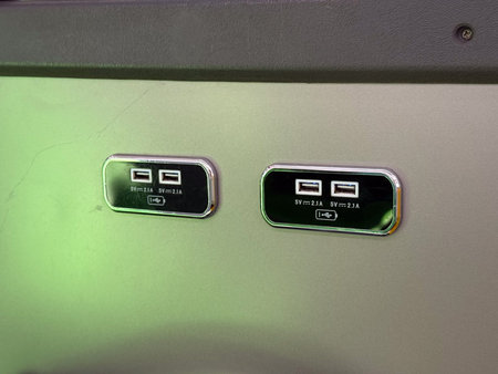 USB charging ports inside city bus for passenger convenience. Technology, travel comfort, modern...