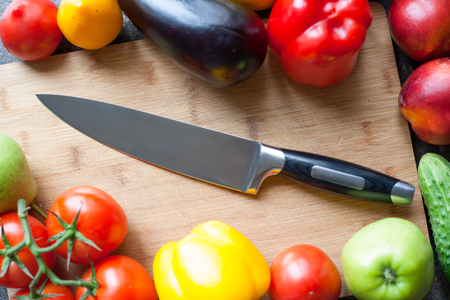 Still life of vegetables and kitchen-knife on cutting boardの写真素材