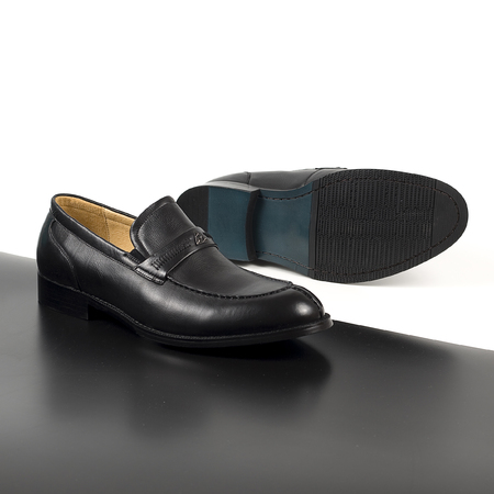 Classic male black leather shoes isolated on a white and blackの写真素材