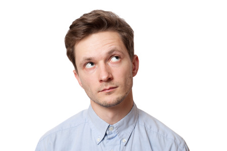 Portrait of a young handsome man looking up. Isolated on white backgroundの写真素材