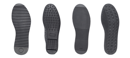 Four black shoe sole in row. Whole background.