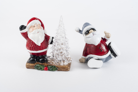 Shiny ceramic retro santa ornament . holding a lantern with Christmas tree at the base of the stautue.の写真素材