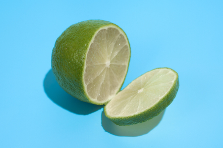 Ripe juicy delicious lime on blue background. Healthy eating and dieting conceptの写真素材