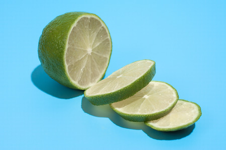 Ripe juicy delicious lime on blue background. Healthy eating and dieting conceptの写真素材