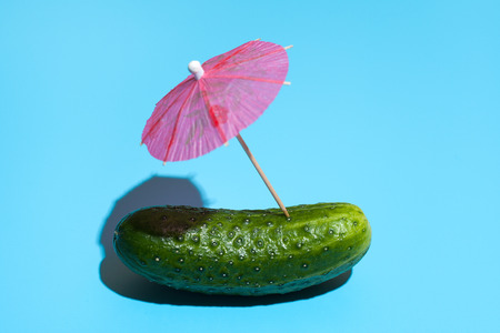 Fresh cucumber with a cocktail umbrella isolated on blue background. Concept of Healthy eating and dieting. Travel and holiday concept
strawの写真素材
