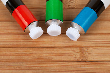 Red green blue RGB colour paints on wood backgroundの写真素材