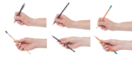 Hand holding pen and brush isolated on white background. Set of multiple imagesの写真素材