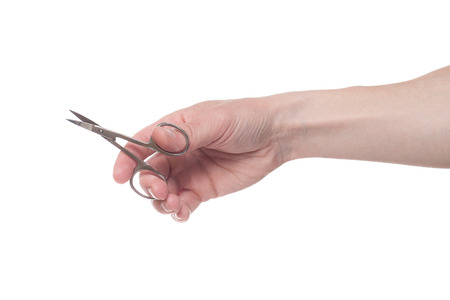 Hand holding scissors for manicure isolated on white background. Health and personal care conceptionの写真素材