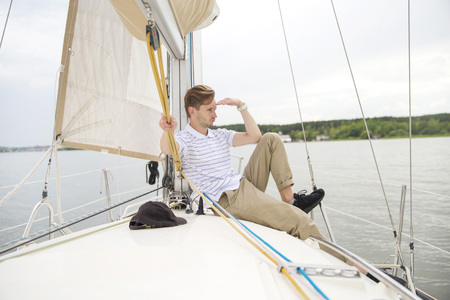 Handsome young man on yachtの写真素材