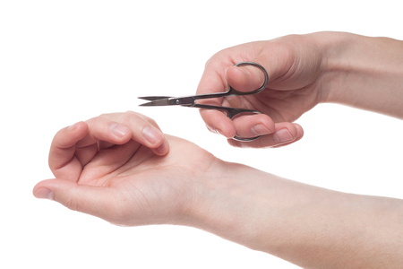 Hand holding scissors for manicure isolated on white background. Health and personal care conceptionの写真素材