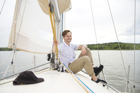 Handsome young man on yachtの写真素材
