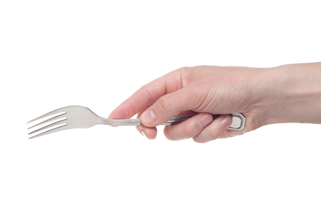 hand holding a silver fork on an isolated white backgroundの写真素材