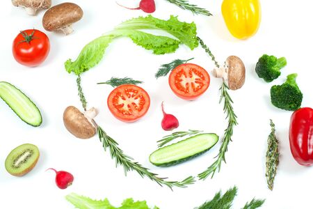 Funny face from different vegetables tomatoes, cucumber, radish, dill and rosemary isolated on white background. Healthy eating and vegan food concept. Kitchenの写真素材
