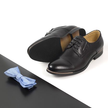 The black man's shoes and accessories isolated on white and black background.の写真素材