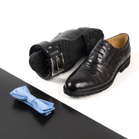 The black man's shoes and accessories isolated on white and black background.の写真素材