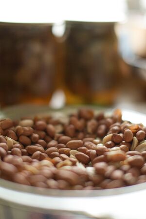Snacks, nuts and chips in glassware on the wooden brown table.の写真素材