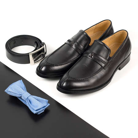 The black man's shoes and accessories isolated on white and black background.の写真素材