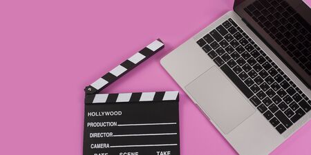 Beauty office desk with laptop notebook and pen and flap on pastel pink background top view flat layの写真素材