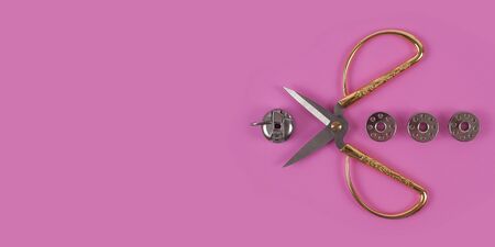 Accessories for sewing thread scissors needle and centimetre on a pink background の写真素材