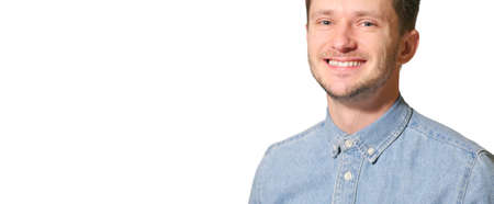 young handsome man looking happy and goofy with a broad, fun smile on white backgroundの写真素材