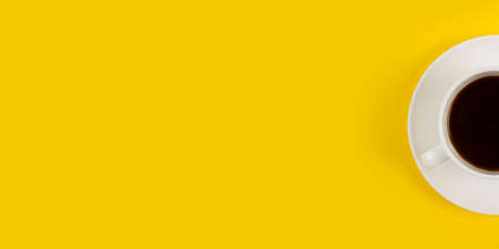 Top view image of coffe cup on yellow background flat lay copy spaceの写真素材