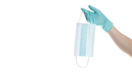 close up of doctor's hand in blue gloves with a medical face mask for protection against infection on white background. Covid. Coronavirusの写真素材