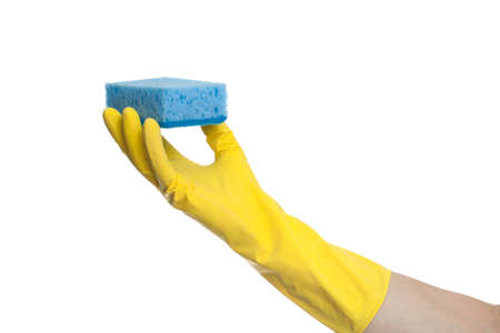 A hand in a yellow rubber glove holds a washing sponge isolated on a white background. House...