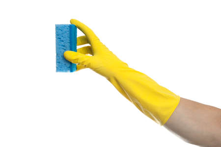 A hand in a yellow rubber glove holds a washing sponge isolated on a white background. House cleaning concept.の写真素材