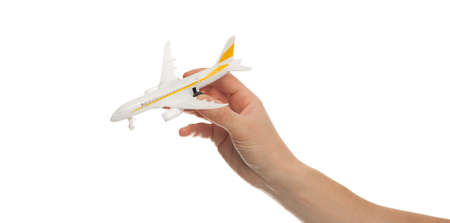 hand holding airplane toy model isolated on white backgroundの写真素材
