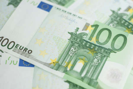 100 euro bill. Europein money banknote. Hundred euro bills on wooden background.の写真素材