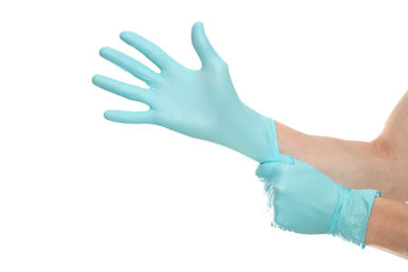 Doctor hands with blue surgical gloves isolated on white background. Medical staff protective gear against coronavirus COVID 19. Health care. Protection conceptの写真素材