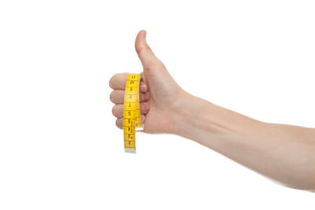 Hand holding a yellow measuring tape, isolated on white background