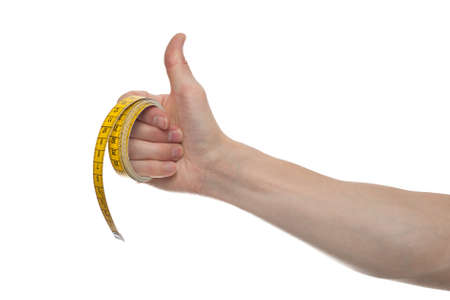 Hand holding a yellow measuring tape, isolated on white backgroundの写真素材