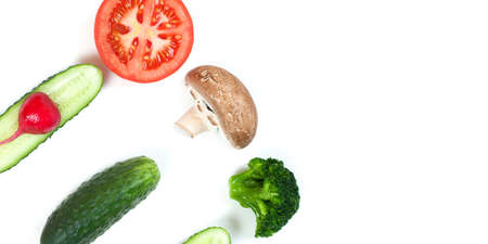 Ingredients for homemade pizza on white background. Top view. Ingredients for salad, slices mushrooms, slices tomatoes, cucumbers and broccoli. Healthy food conceptionの写真素材