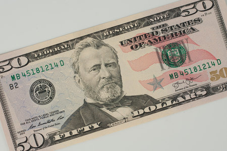 100 Dollars bill and portrait Benjamin Franklin on USA money banknote. Hundred dollar bills on wooden background.の写真素材