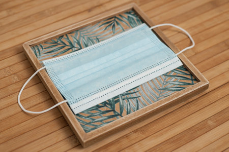 Protective medical mask on wood table background.の写真素材