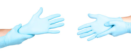 Hands of a medic in the blue latex gloves on white backgroundの写真素材