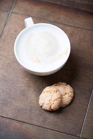 Coffee cup and cookies on wooden table. Top view.の写真素材