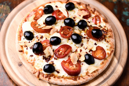 pizza with mozzarella cheese, cherry tomatoes and olivesの写真素材