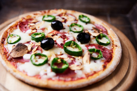 pizza with cheese and olives on a wooden background. tinting. selective focusの写真素材