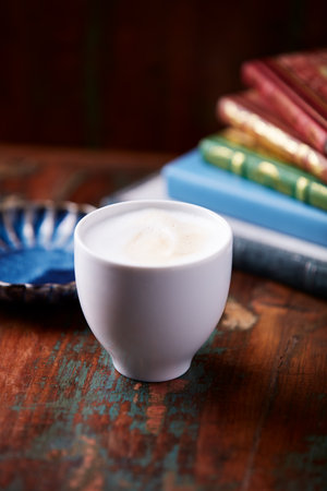 Coffee cup and books on a wooden table. Selective focusの写真素材