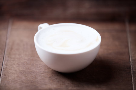 Coffee cup on wooden table, vintage style, selective focusの写真素材